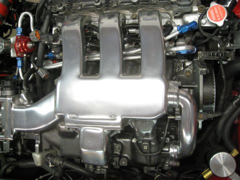 1994 Ford Probe - Close-up of an engine's intake manifold and fuel system components.