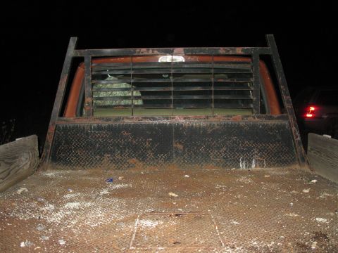 1977 Ford F-250 - Rear view of a 1977 Ford F-250 flatbed truck a metal rack and louvered window.