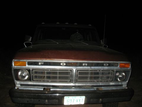 1977 Ford F-250 - The front grille of a 1977 Ford F-250 truck is visible, with the brand name spelled out across the top.