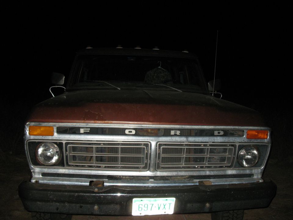 Front view of a 1977 Ford F-250 truck at night. The grille has 'FORD' spelled out