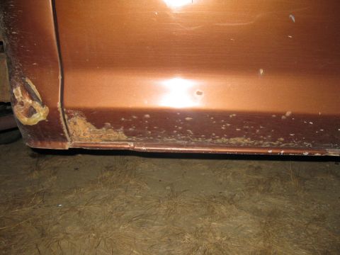 1977 Ford F-250 - Rust damage is visible on the lower body panel of this 1977 Ford F-250.