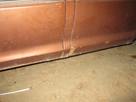1977 Ford F-250 - Close-up of the lower body panel on a 1977 Ford F-250, showing signs of rust.