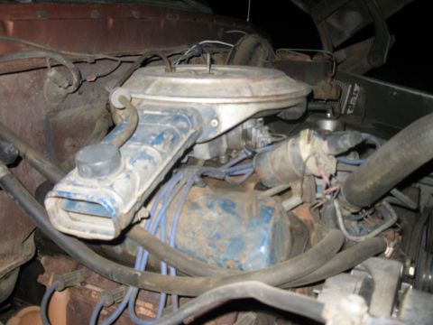 1977 Ford F-250 - The engine bay of a 1977 Ford F-250 pickup truck, showing the V8 engine and air cleaner assembly.