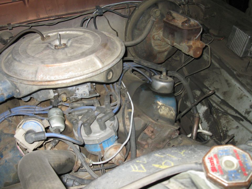 1977 Ford F-250 engine bay showing carburetor, distributor, and brake master cylinder