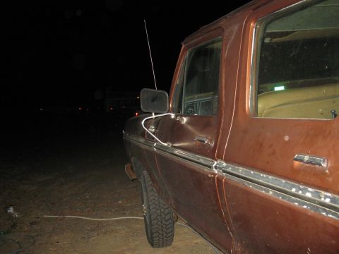 1977 Ford F-250 - Side view of a 1977 Ford F-250 truck at night, showing the door and trim.
