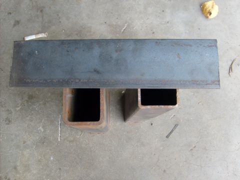 1986 Ford Bronco - A metal plate is supported by two square metal tubes on a concrete surface. The website SUPERMOTORS.NET is visible in the lower right corne…