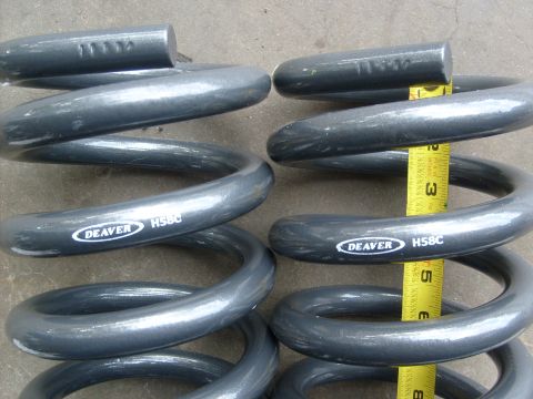 1986 Ford Bronco - Pair of Deaver HS8C coil springs shown with a measuring tape for scale.