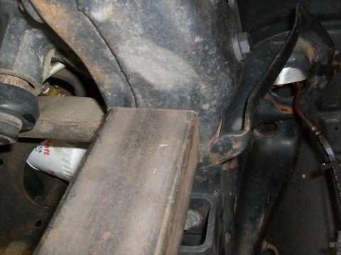 1986 Ford Bronco - This is a close-up view of a vehicle's suspension components and an oil filter.