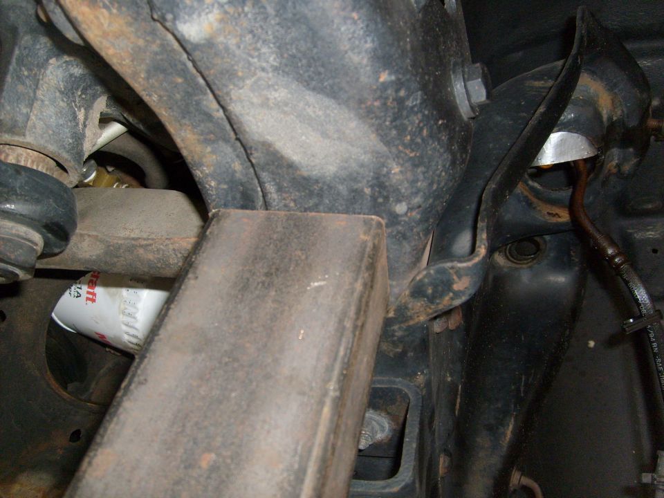 close-up of vehicle's undercarriage with an oil filter visible