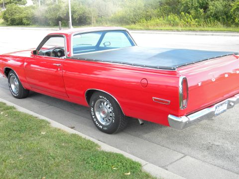1979 Ford F-250 - This red Ford Ranchero has a black bed cover and chrome accents.
