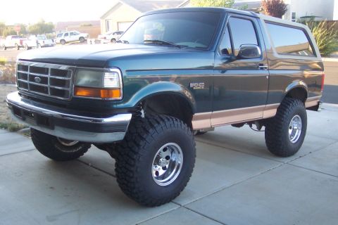 1995 Ford Bronco - This lifted 1995 Ford Bronco is shown from the front three-quarter view on a paved surface.