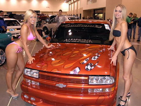 Orange pickup truck with flames and checkered flag graphics, front view