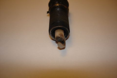 2003 Chrysler Town & Country - A close-up view of a spark plug, showing wear on its electrode.