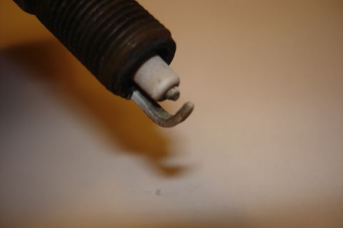 2003 Chrysler Town & Country - A single spark plug is shown in detail, highlighting its electrode and ceramic insulator.