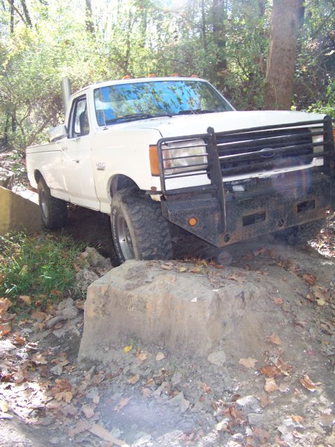 1987 Ford F-250 - This 1987 Ford F-250 is shown off-road, demonstrating its capability on challenging terrain.