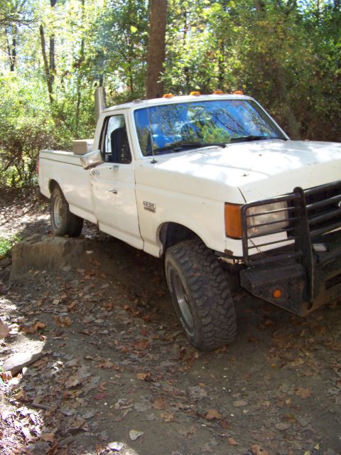 1987 Ford F-250 - This 1987 Ford F-250 is shown off-road with its large tires and prominent exhaust stack.