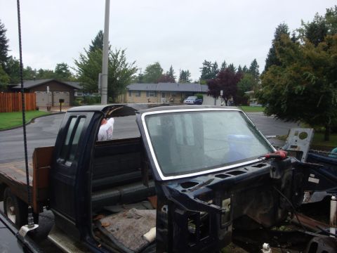 1989 Ford Bronco - This truck cab appears to be undergoing disassembly or repair, with its front end removed.