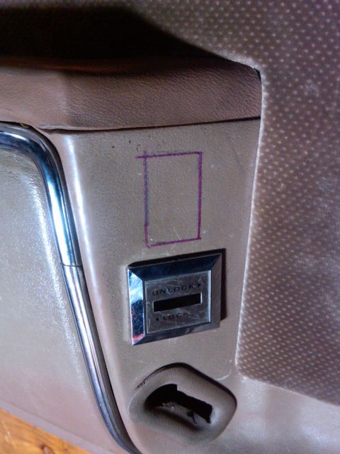 1986 Ford Bronco - Interior door panel detail with lock switch and a marked area.