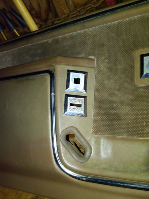 1986 Ford Bronco - Close-up of car door interior panel with window lock and unlock switches.