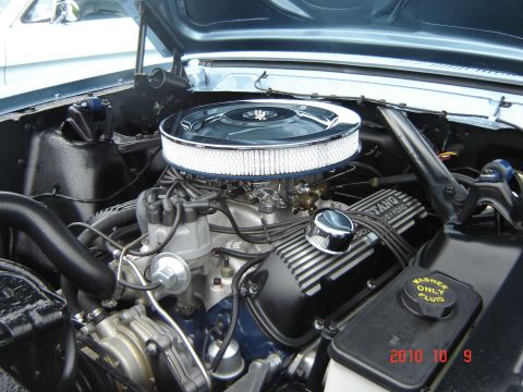 1993 Ford Bronco - Close-up of a 1967 Ford Mustang engine bay, showing the V8 engine and air intake system.