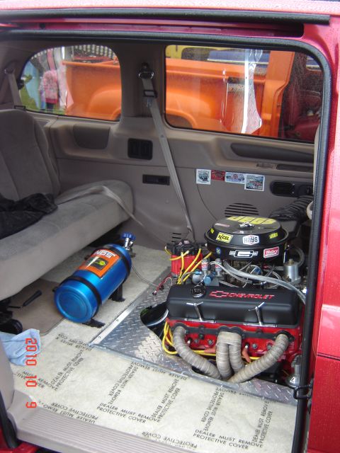 1993 Ford Bronco - Interior view of a vehicle modified with a Chevrolet engine and NOS tank, with other vehicles seen through the windows.