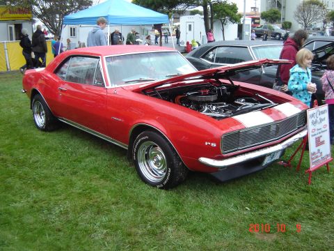 1993 Ford Bronco - 1967 Chevrolet Camaro Rally Sport on display at an outdoor car show.