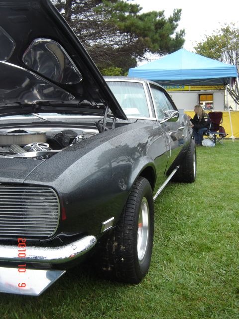1993 Ford Bronco - A dark gray 1969 Chevrolet Camaro is displayed with its hood open at an outdoor event.