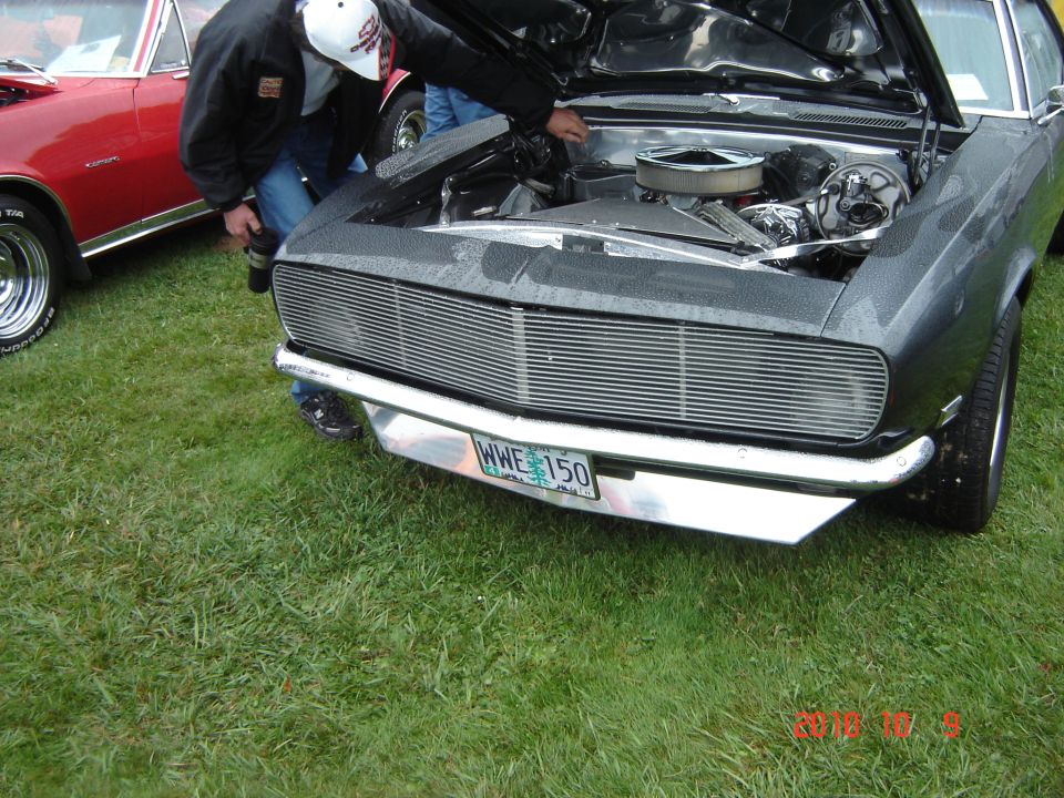 Gray car front with custom grille and license plate WWE 150