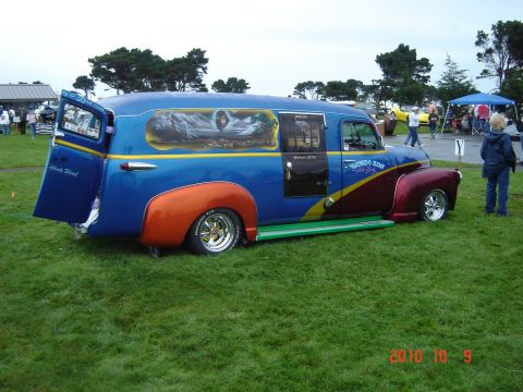 1993 Ford Bronco - Custom panel van with elaborate murals and two-tone paint scheme displayed outdoors.