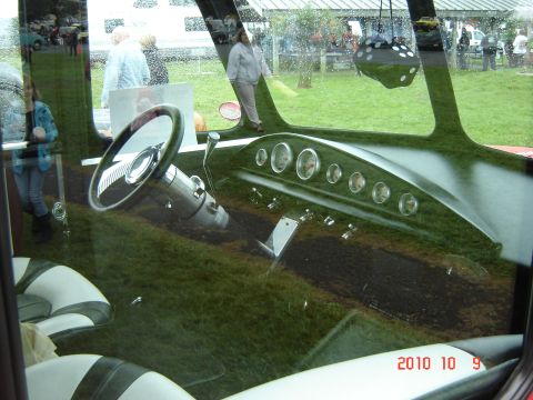 1993 Ford Bronco - Interior view of a custom vehicle with unique green carpeting and a retro dashboard.