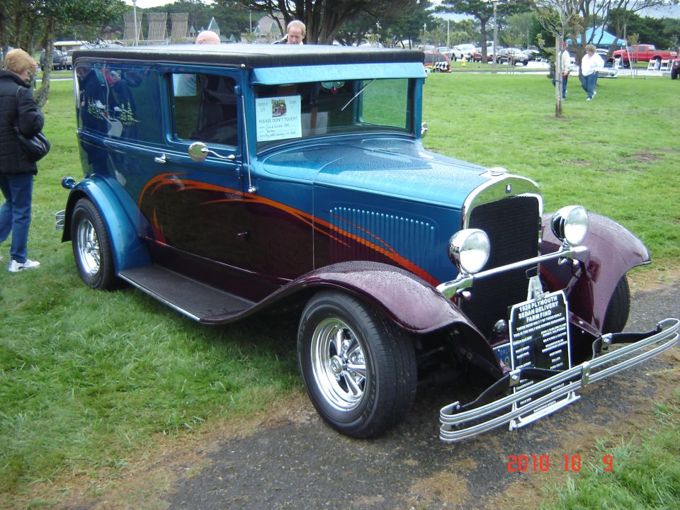 Blue and dark red sedan with flame graphics, chrome bumper, and custom wheels
