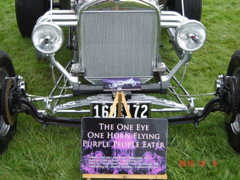 1993 Ford Bronco - A custom hot rod is displayed with a descriptive sign detailing its name and build information.
