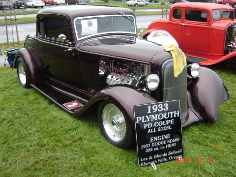 1993 Ford Bronco - A 1933 Plymouth PD Coupe All Steel with a 1957 Dodge Hemi engine is displayed at a car show.