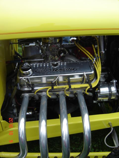 1993 Ford Bronco - Close-up of a V8 engine with "Ford Racing" valve covers and shiny exhaust headers.