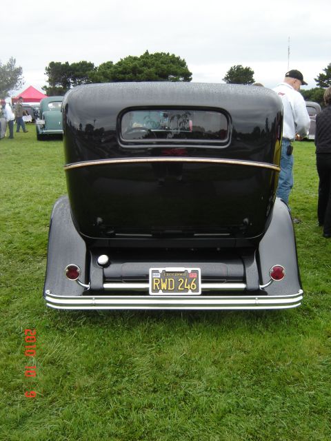 1993 Ford Bronco - Black 1930s sedan at a car show. License plate RWD 246 is visible on the rear.