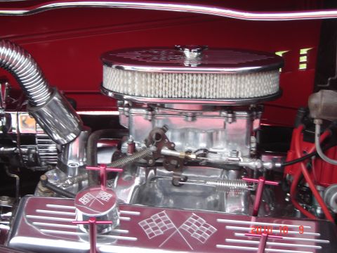 1993 Ford Bronco - Close-up of a polished engine bay a prominent air filter and carburetor assembly.