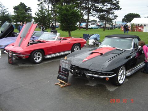 1993 Ford Bronco - Two classic Chevrolet Corvette Sting Rays are displayed at an outdoor event, with one having its hood open.