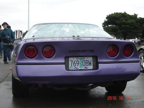 1993 Ford Bronco - A purple Corvette is seen from the rear at an outdoor event. The license plate reads Oregon 769 DBW.