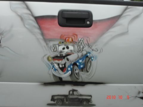 1993 Ford Bronco - Airbrushed artwork of a cartoon tow truck adorns the tailgate of a white vehicle.