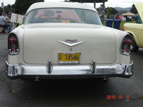 1993 Ford Bronco - Rear view of a 1955 Chevrolet Bel Air at an outdoor event. Another car is visible to the right.