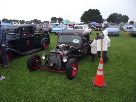 1993 Ford Bronco - A custom hot rod is displayed at an outdoor car show with several other vehicles present.