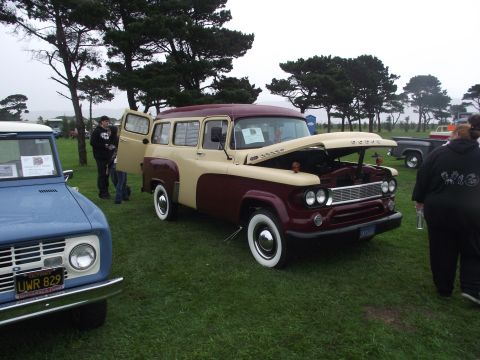 1993 Ford Bronco - A vintage Dodge Suburban is displayed with its hood and driver's door open at an outdoor event.