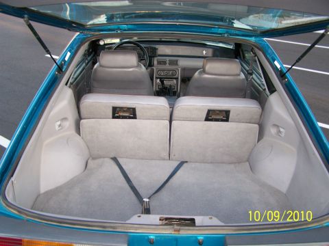 1995 Ford Bronco - The interior of a teal car is visible, folded rear seats and a carpeted cargo area. A date stamp indicates the photo was taken on 10/09/201…
