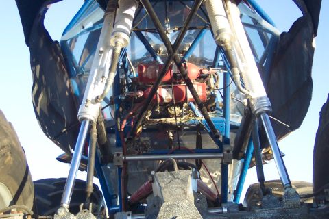 1995 Ford Bronco - Close-up view of a monster truck's engine and suspension components.