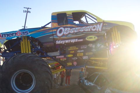 1995 Ford Bronco - Monster truck Obsession displays numerous sponsor logos on its side panel.