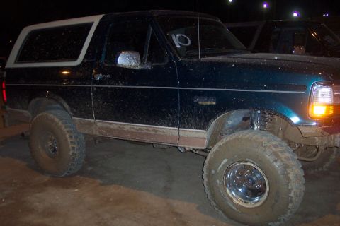 1995 Ford Bronco - This Ford Bronco appears to be a 1995 model, seen off-road with mud splattered on its body.