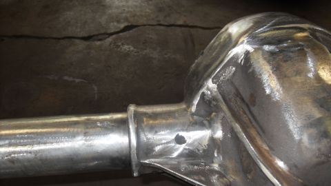 1997 Ford Ranger - Shiny metal rear axle housing with visible welds, likely undergoing restoration or modification.