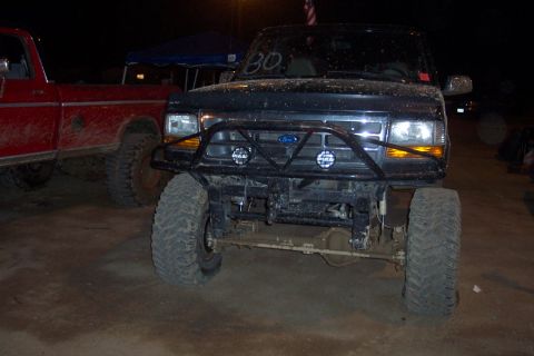 1995 Ford Bronco - Front view of a modified 1995 Ford Bronco with a custom bumper and off-road tires.