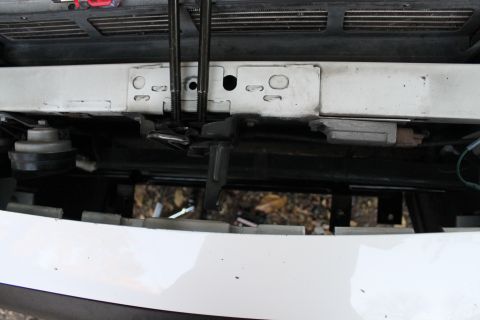 2003 Ford Crown Victoria - Front view of a 2003 Ford Crown Victoria showing the bumper, mounting hardware, and a horn.