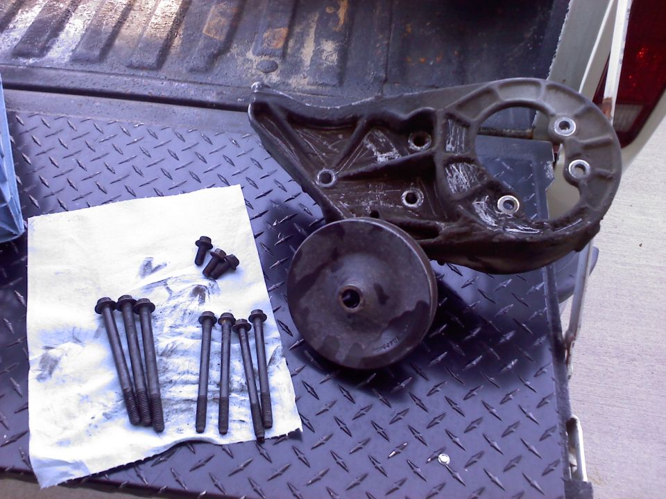 Power steering pump bracket and bolts on truck bed